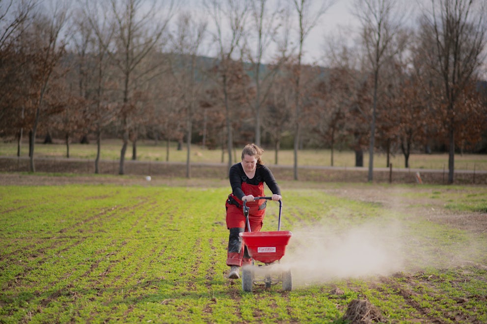 woman fertilizing field
