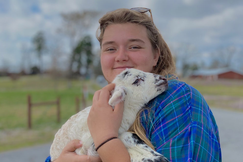 woman holding a lamb