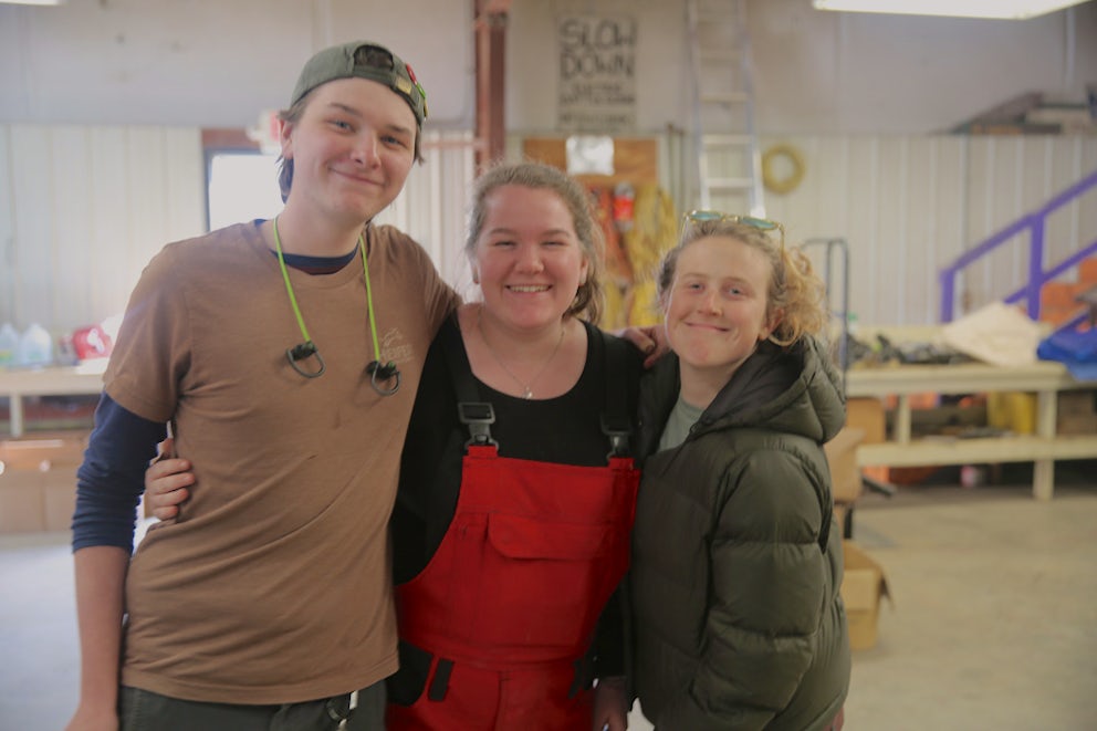 three volunteers smiling at the camera