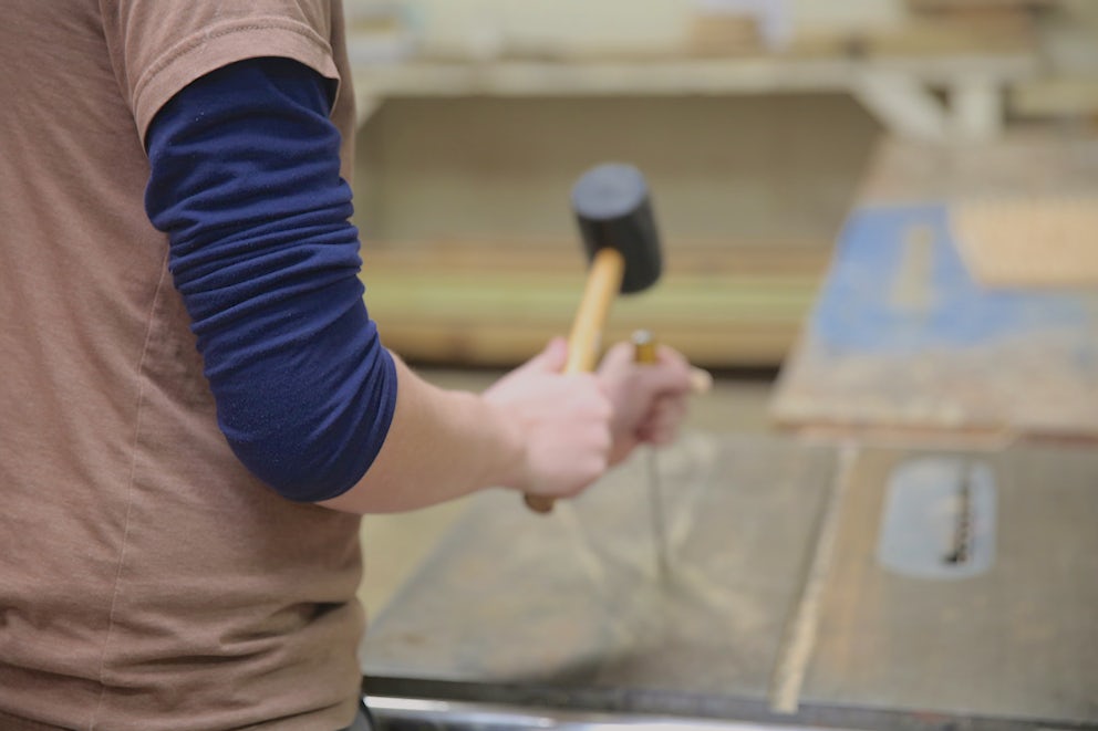 volunteer using a hammer