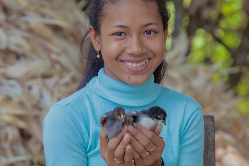 teen holding baby chicks