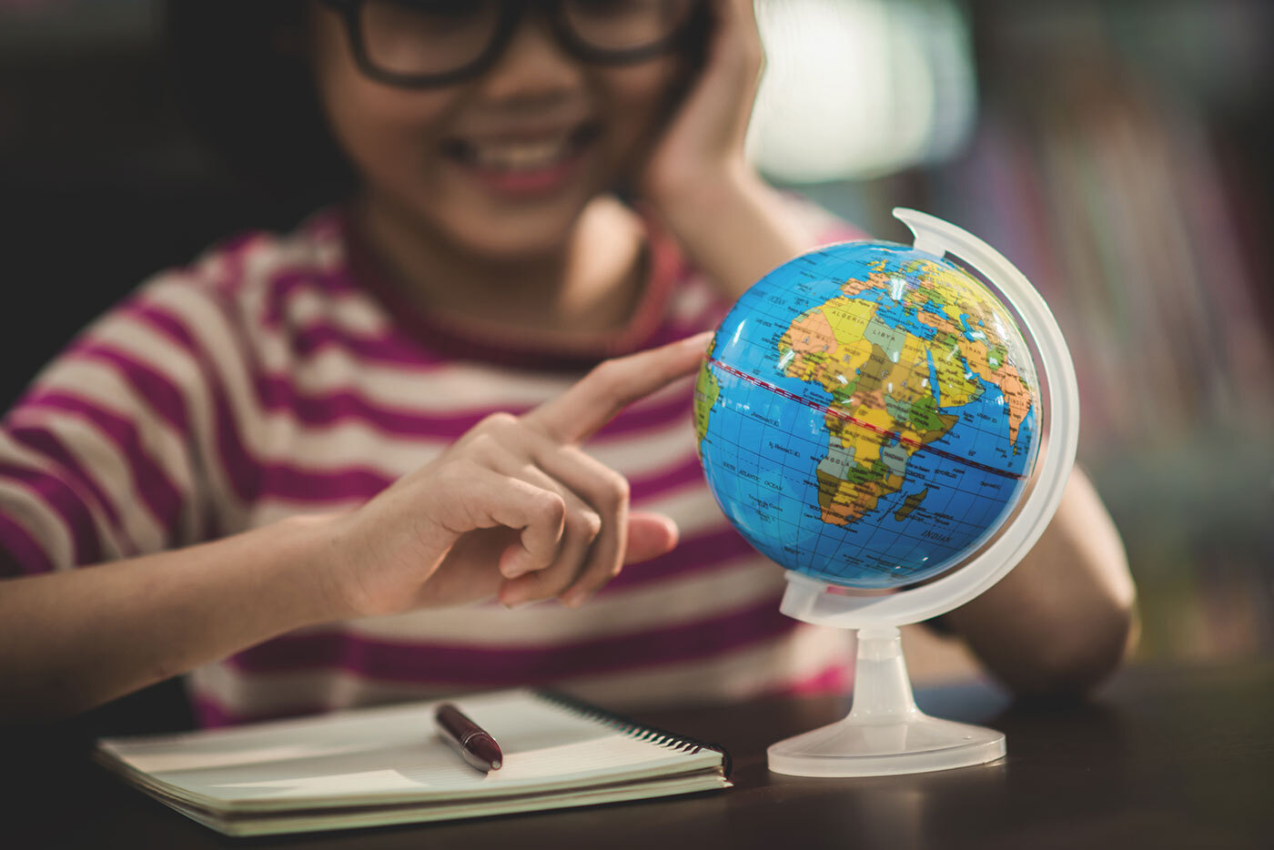 Student playing with a globe